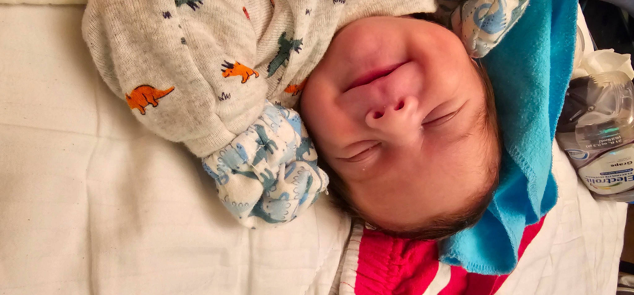 Gage is registered to the contest to win money with this photo: arm, baby_toddler_clothing, cheek, comfort, cool, eye, eyebrow, eyelash, finger, hand, happy, joy, linens, lip, mouth, neck, nose, outerwear, person, skin
