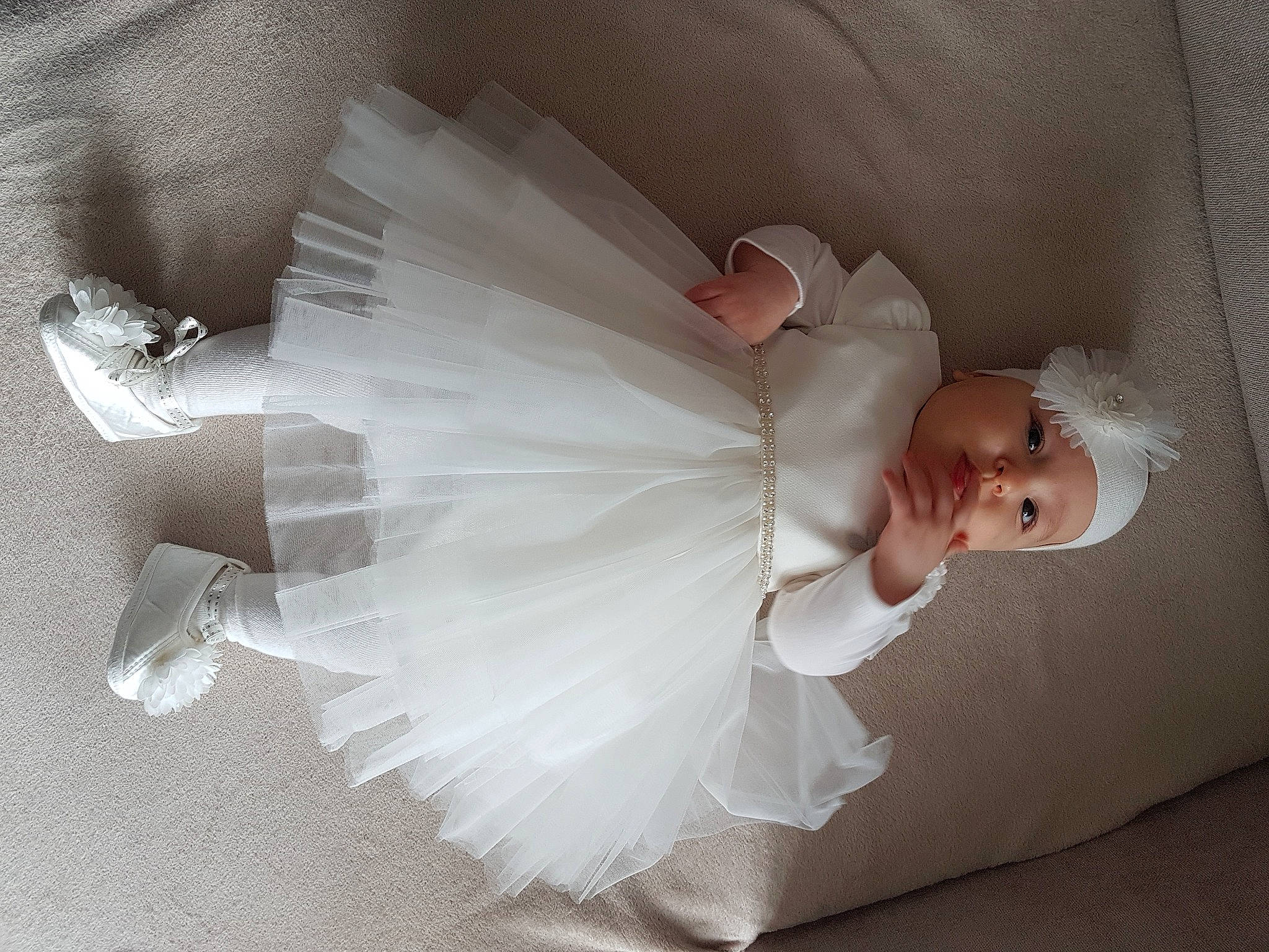 Eva participe au concours pour gagner de l'argent avec cette photo : angel, arm, baby_toddler_clothing, bridal_accessory, bridal_clothing, bridal_party_dress, day_dress, dress, embellishment, event, fashion_accessory, feather, flash_photography, formal_wear, gown, happy, headpiece, headwear, person, smile