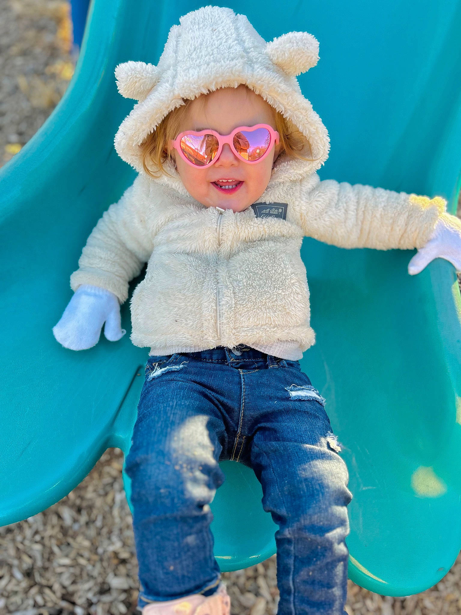 Haven is registered to the contest to win money with this photo: azure, blue, cap, clothing, eyewear, glasses, goggles, happy, hat, jeans, leg, organ, person, shoe, sleeve, smile, sun_hat, sunglasses, textile, vision_care