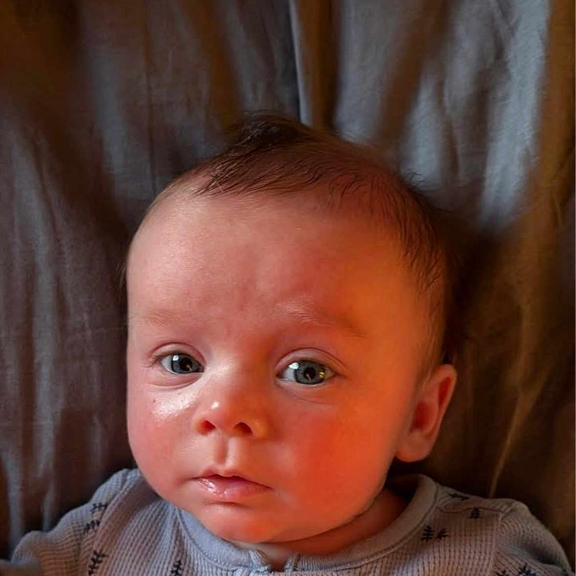 Hudson is registered to the contest to win money with this photo: baby, bodypart, clothing, couch, ear, face, frown, furniture, hair, happy, head, knitwear, newborn, person, photography, portrait, sad, selfie, smile, sweater