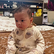 Soren joined the competition — help win amazing prizes! baby, infant, onesie, elephant_pattern, bedspread, brown, floral, bedroom, plush_toys, shelf, window_blinds, curious, seated, indoors, child, person, cozy, soft_lighting, cute, young