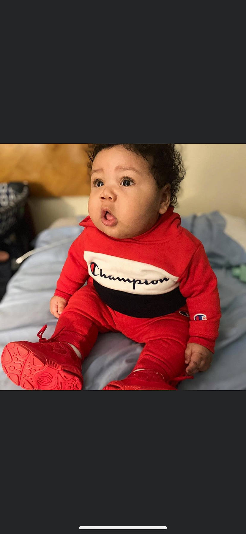 Sekani joined the competition — help win amazing prizes! baby, beauty, cheek, child, child_model, face, facial_expression, head, lip, outerwear, person, photography, red, sitting, skin, sleeve, smile, surprise, t_shirt, toddler