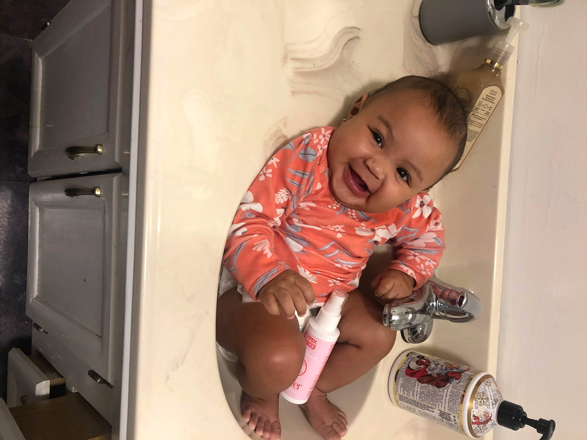 Esme joined the competition — help win amazing prizes! baby, baby_products, baby_toddler_clothing, child, door, drinkware, flooring, fun, happy, human_leg, knee, person, room, shorts, sitting, skin, smile, t_shirt, thigh, tin_can