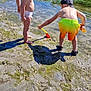 Ayden a rejoint le concours — aidez-le/la à gagner de superbes lots ! barefoot, beach, boat, cap, child, diaper, exploring, hat, mud, nature, outdoor, play, sand, shore, shorts, shovel, sunlight, toddler, water, water_bottle