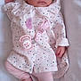 Aya is registered to the contest to win money with this photo: baby, infant, pacifier, blanket, clothing, pink, white, lying_down, cute, child, newborn, face, hands, feet, soft_texture, patterned_clothes, indoor, portrait, young, resting