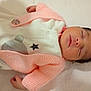 Aya joined the competition — help win amazing prizes! baby, newborn, sleeping, infant, pink_sweater, knitted_clothing, white_onesie, stars, bear_design, blanket, resting, peaceful, cute, small_hands, soft_texture, portrait, indoors, child, face, closed_eyes