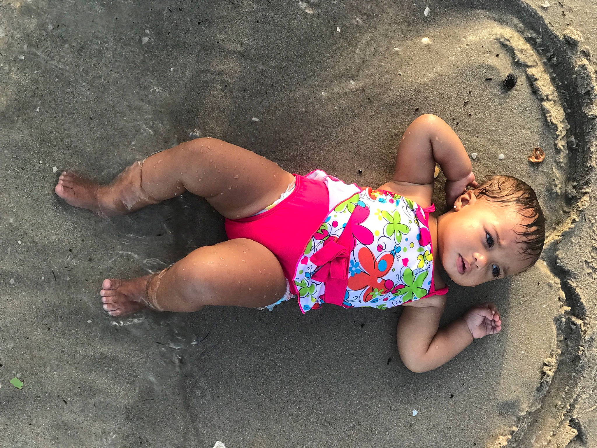 Kennaleigha is registered to the contest to win money with this photo: asphalt, baby, barefoot, body_of_water, fun, grass, happy, headgear, knee, leg, leisure, people_in_nature, person, road, road_surface, shorts, sidewalk, thigh, toddler, tree