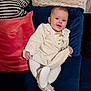 Sabrina joined the competition — help win amazing prizes! baby, child, smile, face, couch, pillow, clothing, tights, shoes, indoor, happy, portrait, cute, sitting, cozy, fabric, texture, home, infant, person