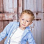Wahid participe au concours pour gagner de l'argent avec cette photo : blue_checkered_shirt, blue_eyes, boy, casual_clothing, child, curly_hair, cute, denim_jeans, happy, indoor, leaning, light_skin, person, portrait, posing, rustic, smiling, studio_photo, white_tshirt, wooden_background