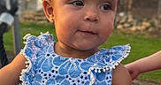 Xiomora is registered to the contest to win money with this photo: toddler, child, blue_dress, outdoor, grass, curious_expression, phone_screenshot, app_icons, status_bar, person, young_child, portrait, summer, casual, daylight, cute, small_child, face, standing, natural_light