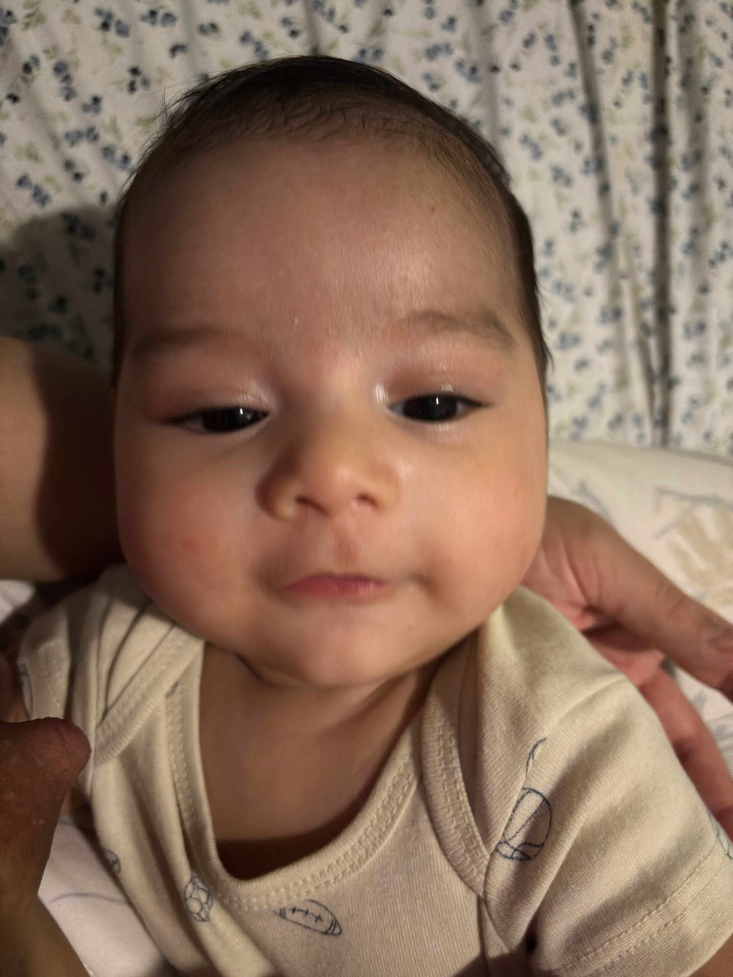 Ethan joined the competition — help win amazing prizes! baby, infant, face, closeup, onesie, hand, person, child, skin, portrait, cute, young, sleepy, indoor, soft, comfort, expression, resting, background, fabric