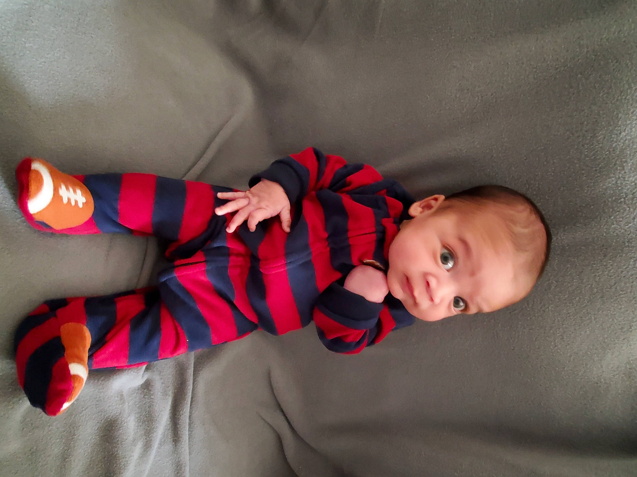 Nehemiah joined the competition — help win amazing prizes! arm, baby, baby_toddler_clothing, child, comfort, finger, gesture, hand, linens, mammal, orange, pattern, person, plaid, skin, sleeve, sock, toddler, vertebrate, wood