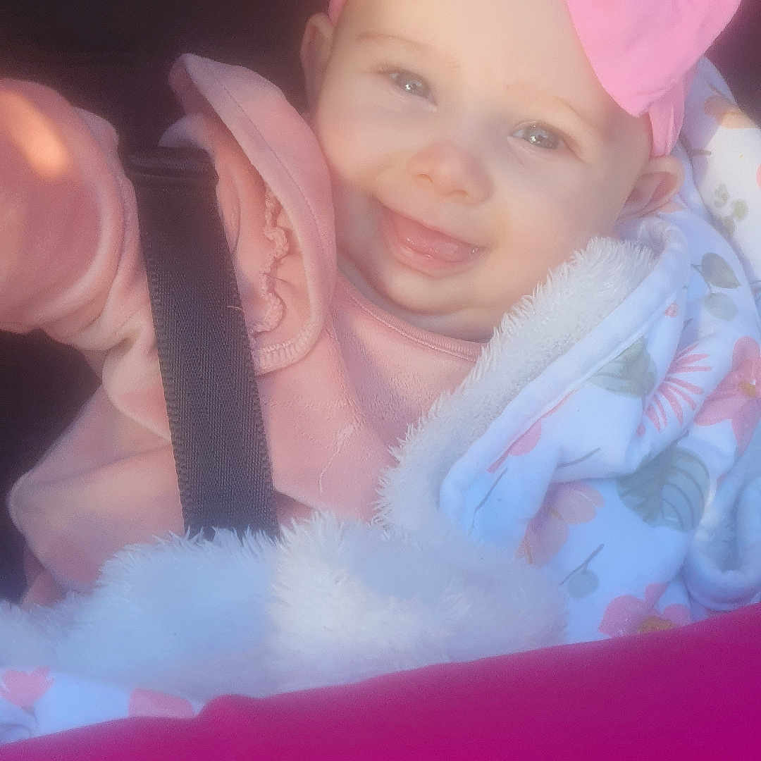 Nevaeh is registered to the contest to win money with this photo: accessories, baby, belt, bodypart, bonnet, cap, clothing, coat, costume, face, happy, hat, head, hood, jacket, person, photography, portrait, purple, smile