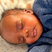 Makai is registered to the contest to win money with this photo: baby, sleeping, infant, closeup, face, arm, knitwear, blue_sweater, blanket, stars, peaceful, rest, soft_light, cute, child, portrait, skin, eyelids, nose, mouth