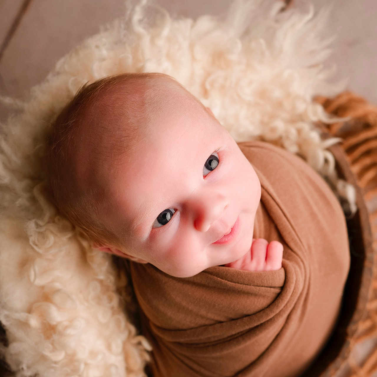 Waylon is registered to the contest to win money with this photo: baby, blanket, blue_eyes, child, cozy, cute, face, flesh, furniture, head, indoors, infant, newborn, portrait, skin, smile, soft, swaddle, warm, wrapped