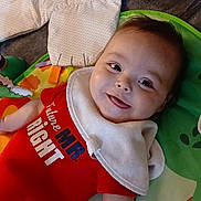 Onyx joined the competition — help win amazing prizes! baby, child, smiling, onesie, bib, play_mat, toy, infant, lying_down, happy, cute, face, skin, arm, hand, clothing, indoor, colorful, soft_toy, blanket