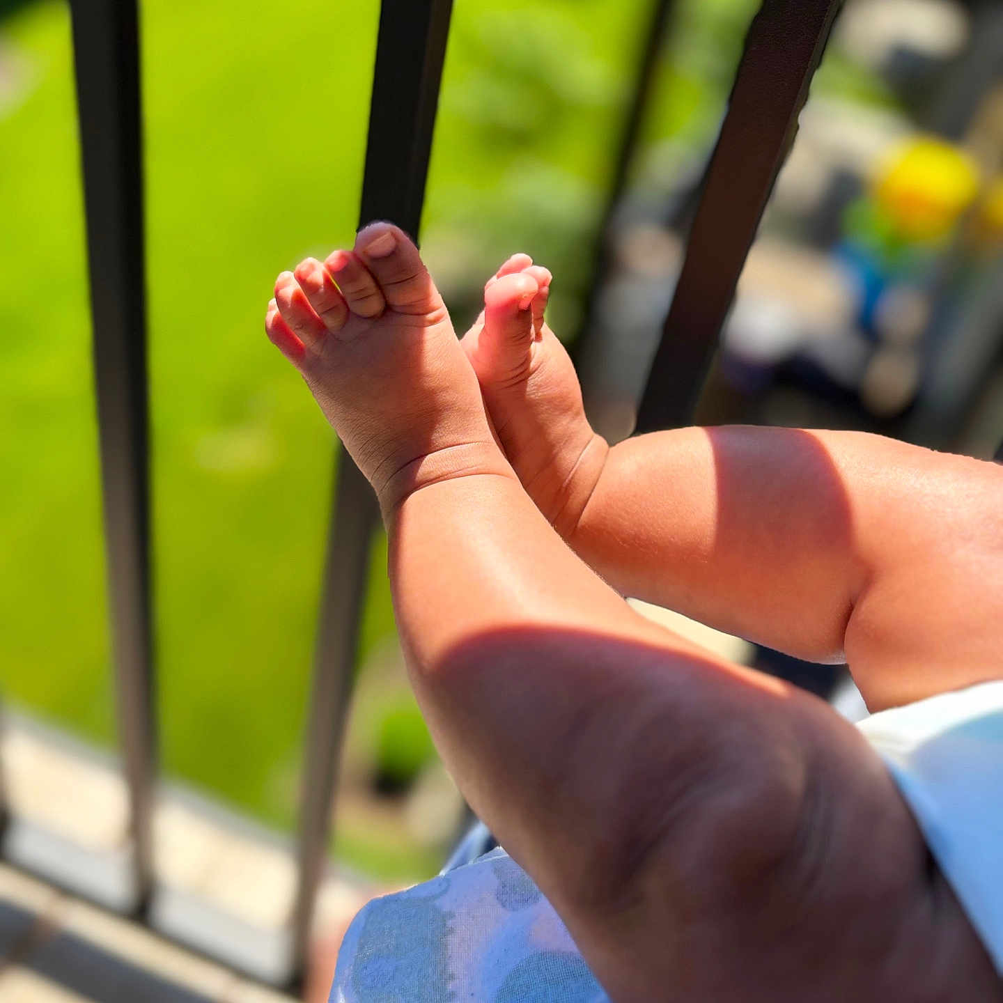Baba joined the competition — help win amazing prizes! baby, legs, feet, infant, skin, sunlight, shadow, outdoor, railing, blurred_background, child, closeup, toddler, summer, warm, playful, small, human_limb, baby_clothing, soft