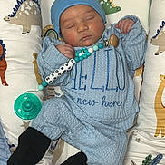 Camden joined the competition — help win amazing prizes! baby, newborn, sleeping, blue_outfit, hat, pacifier, beads, cushion, dinosaur_pattern, infant, cozy, child, soft_toys, crib, black_socks, cute, resting, indoors, peaceful, clothing