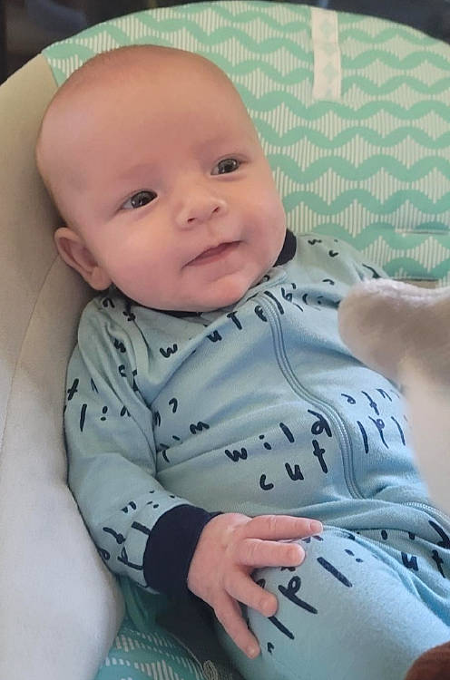 Jace is registered to the contest to win money with this photo: baby, baby_toddler_clothing, cheek, chin, comfort, eye, eyebrow, face, finger, head, human_body, iris, lip, mouth, neck, nose, person, skin, sleeve, smile