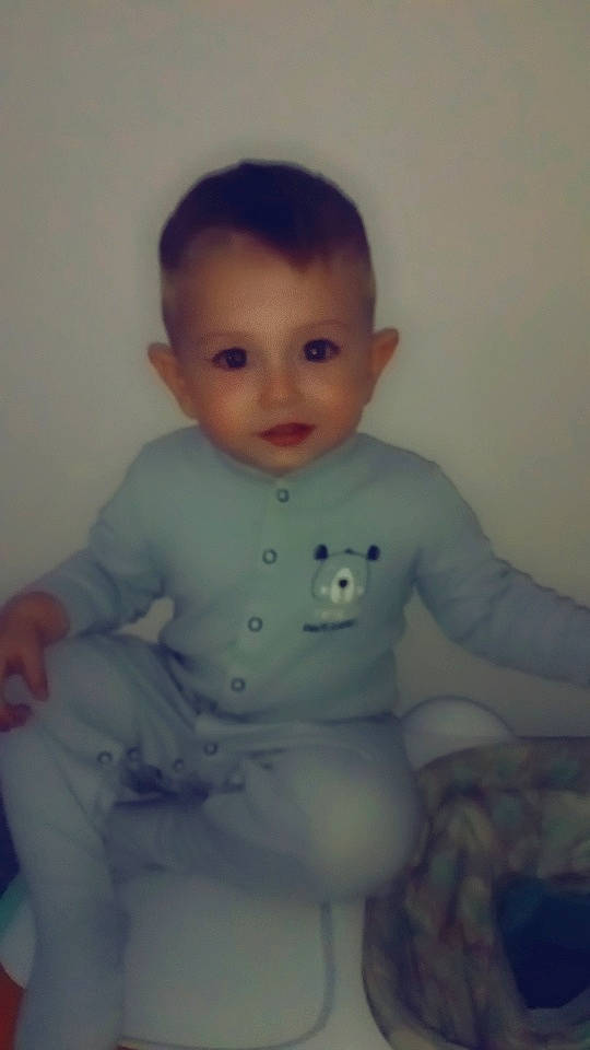 Brody is registered to the contest to win money with this photo: arm, baby, cheek, child, eye, face, forehead, head, iris, lip, mouth, nose, person, skin, sleeve, smile, standing, toddler, trunk