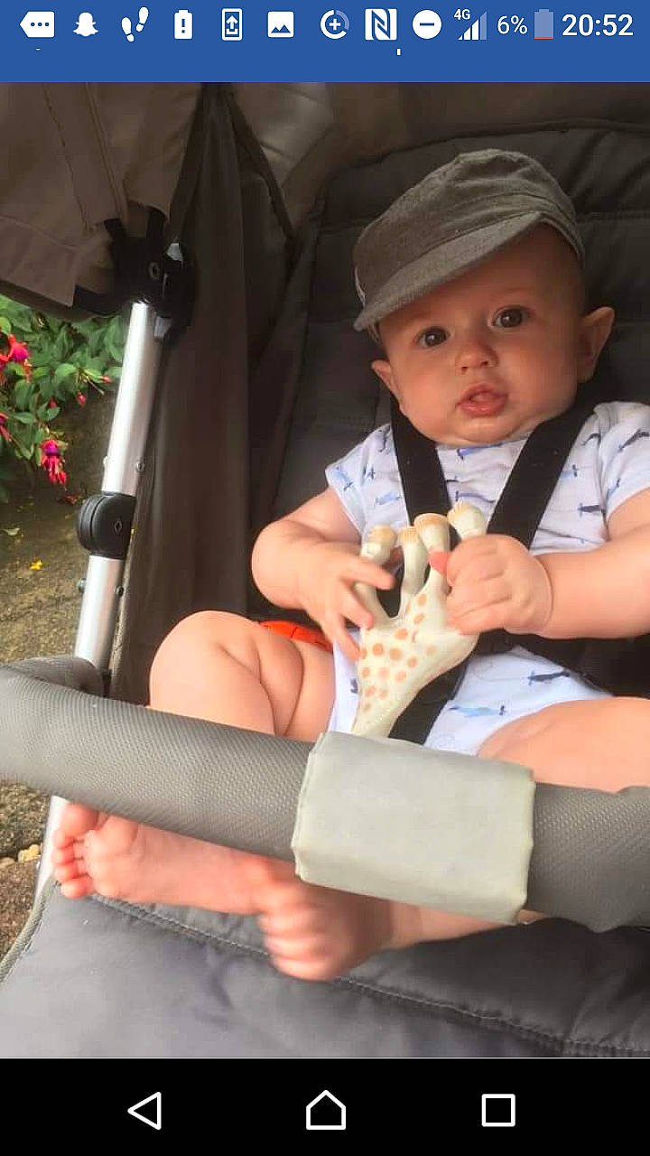 Brody is registered to the contest to win money with this photo: auto_part, baby, child, finger, headwear, leg, person, product, sitting, skin, toddler