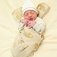 Ayden participe au concours pour gagner de l'argent avec cette photo : baby, newborn, swaddle, blanket, hat, sleeping, infant, cozy, bed, hands, face, portrait, cute, nursery, soft_texture, patterned_fabric, cream_background, peaceful, wrapped, sleeping_baby