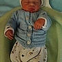 newborn, baby, sleeping, knitted_clothing, blue_sweater, white_pants, patterned_pants, blanket, soft, cozy, infant, cute, resting, child, small_hands, headwear, warm, indoors, portrait, peaceful