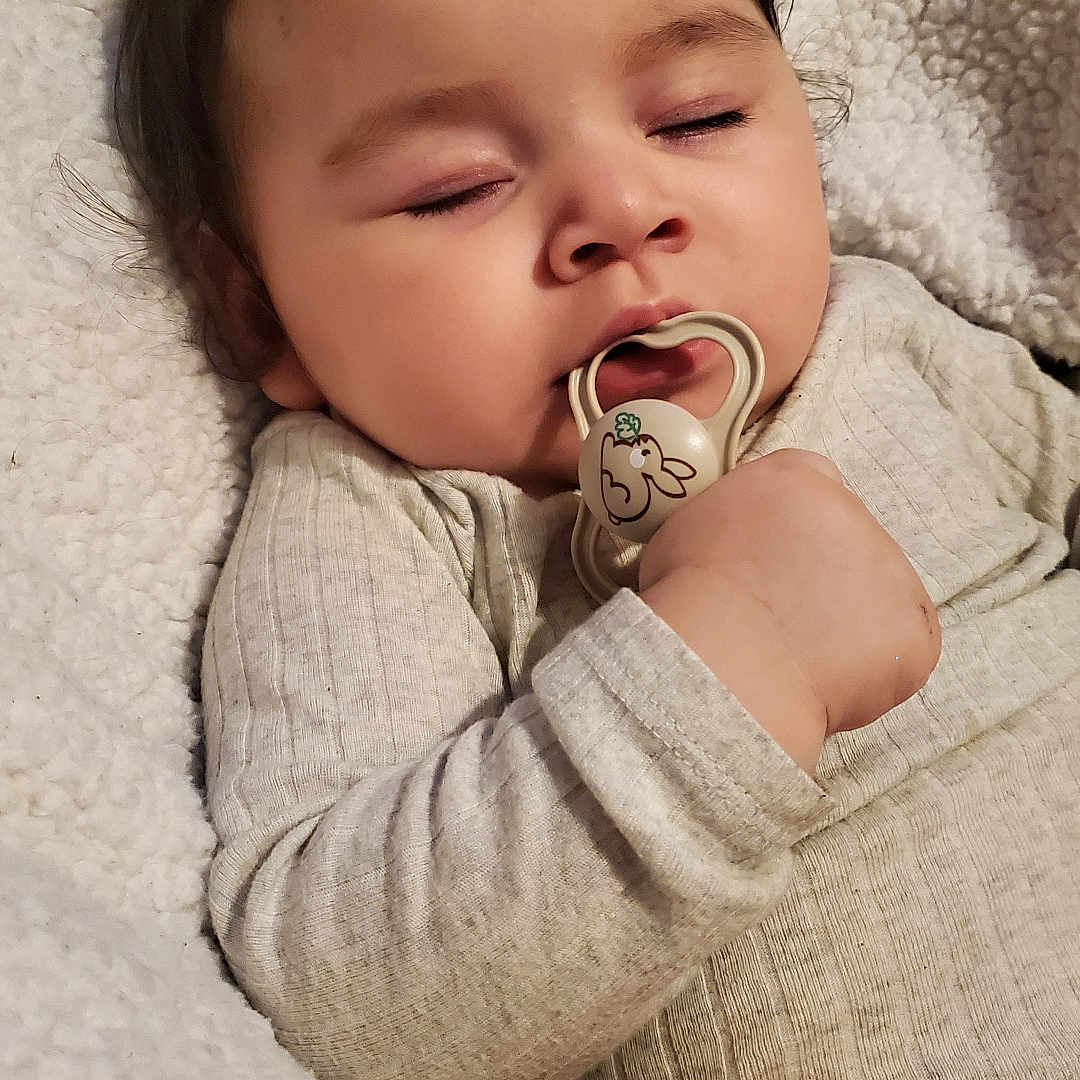 Amalea joined the competition — help win amazing prizes! baby, blanket, child, clothing, cozy, cuddle, cute, face, hand, indoors, infant, pacifier, peaceful, portrait, relaxation, rest, sleeping, soft, warm, young