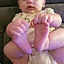 baby, infant, child, couch, hands, feet, holding, diaper, onesie, indoor, person, face, head, skin, furniture, closeup, sitting, curious, home, soft