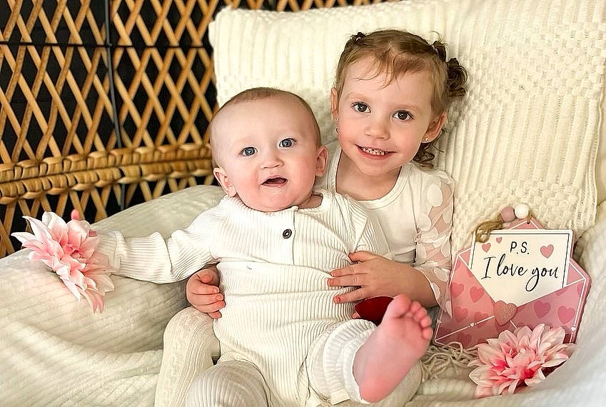 Karson is registered to the contest to win money with this photo: baby, baby_toddler_clothing, cheek, child, comfort, event, face, facial_expression, flash_photography, fun, gesture, happy, iris, joy, pattern, person, pink, sitting, skin, sleeve