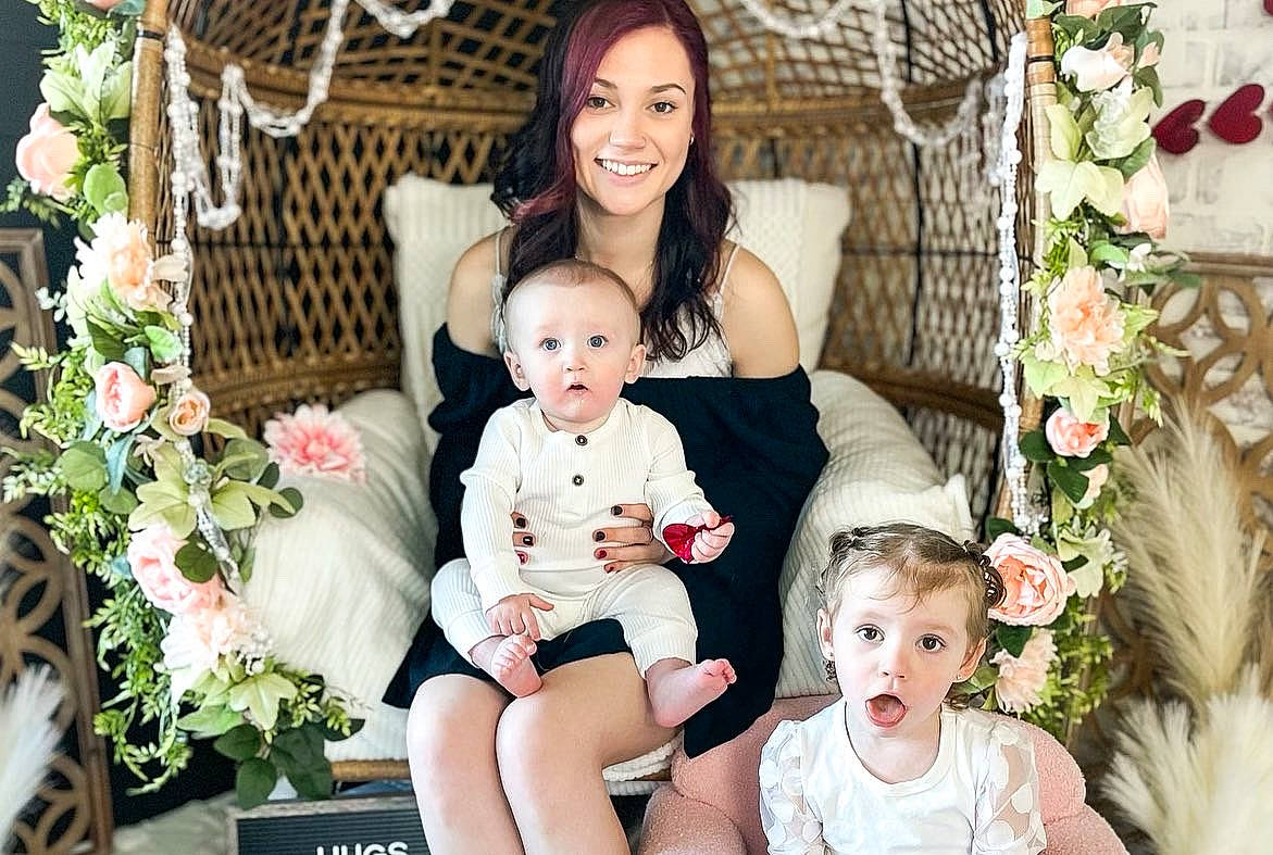 Kinsley is registered to the contest to win money with this photo: baby, beauty, child, event, eye, face, facial_expression, family_taking_photos_together, flash_photography, flower, flower_arranging, happy, head, joy, people, person, photograph, pink, plant, smile