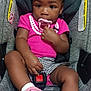 baby, toddler, child, car_seat, pink_clothing, pacifier, sneakers, seatbelt, safety, cute, portrait, indoor, person, young_child, footwear, white_socks, car, seat, black_hair, infant