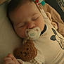 Simon participe au concours pour gagner de l'argent avec cette photo : baby, sleeping, pacifier, teddy_bear, pajamas, infant, cute, child, soft_toy, bed, resting, peaceful, face, hand, clothing, indoors, comfort, cozy, baby_toys, blanket