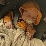 baby, sleeping, pacifier, hoodie, car_seat, blanket, teddy_bear, child, infant, cozy, cute, hands, comfort, rest, indoors, soft, warm, peaceful, secured, young