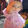 Athena is registered to the contest to win money with this photo: baby, child, girl, purple_dress, headband, bow, smile, toy, carpet, indoor, face, cute, portrait, sitting, playful, hands, expression, soft_light, floral_pattern, closeup
