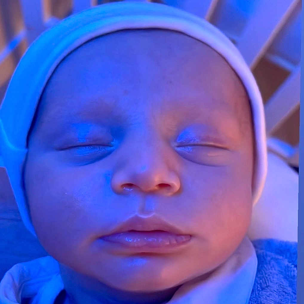 Naham participe au concours pour gagner de l'argent avec cette photo : baby, blue_light, child, closeup, clothing, cozy, crib, cute, face, hat, headwear, indoors, infant, newborn, peace, peaceful, portrait, resting, sleeping, soft_texture