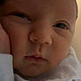 baby, newborn, face, closeup, expression, hand, skin, infant, person, portrait, sleepy, clothing, soft, young, cute, indoors, resting, head, eyes, warm_light