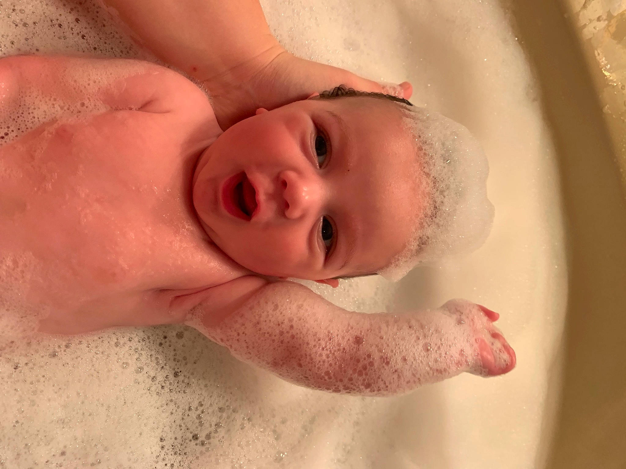 Kolton is registered to the contest to win money with this photo: arm, baby, cheek, comfort, eyebrow, eyelash, face, gesture, hand, happy, human_body, iris, jaw, lip, mouth, neck, nose, person, skin, smile