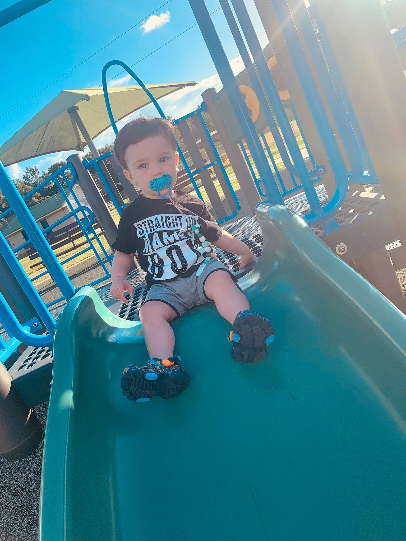 Kolton joined the competition — help win amazing prizes! aqua, automotive_exterior, baby, blue, bumper, child, city, electric_blue, flash_photography, fun, happy, leisure, outdoor_play_equipment, person, playground, recreation, shorts, sitting, sky, t_shirt
