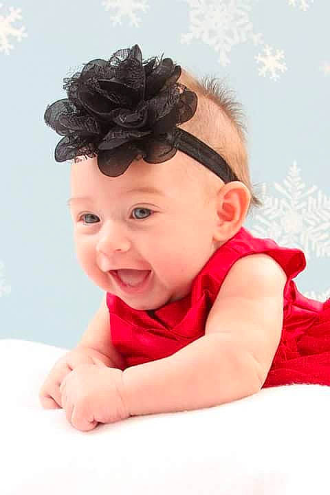 Avyanna is registered to the contest to win money with this photo: baby, black_hair, cheek, child, child_model, fashion_accessory, forehead, hair, hair_accessory, hairstyle, headband, headgear, headpiece, headwear, person, pink, smile, toddler
