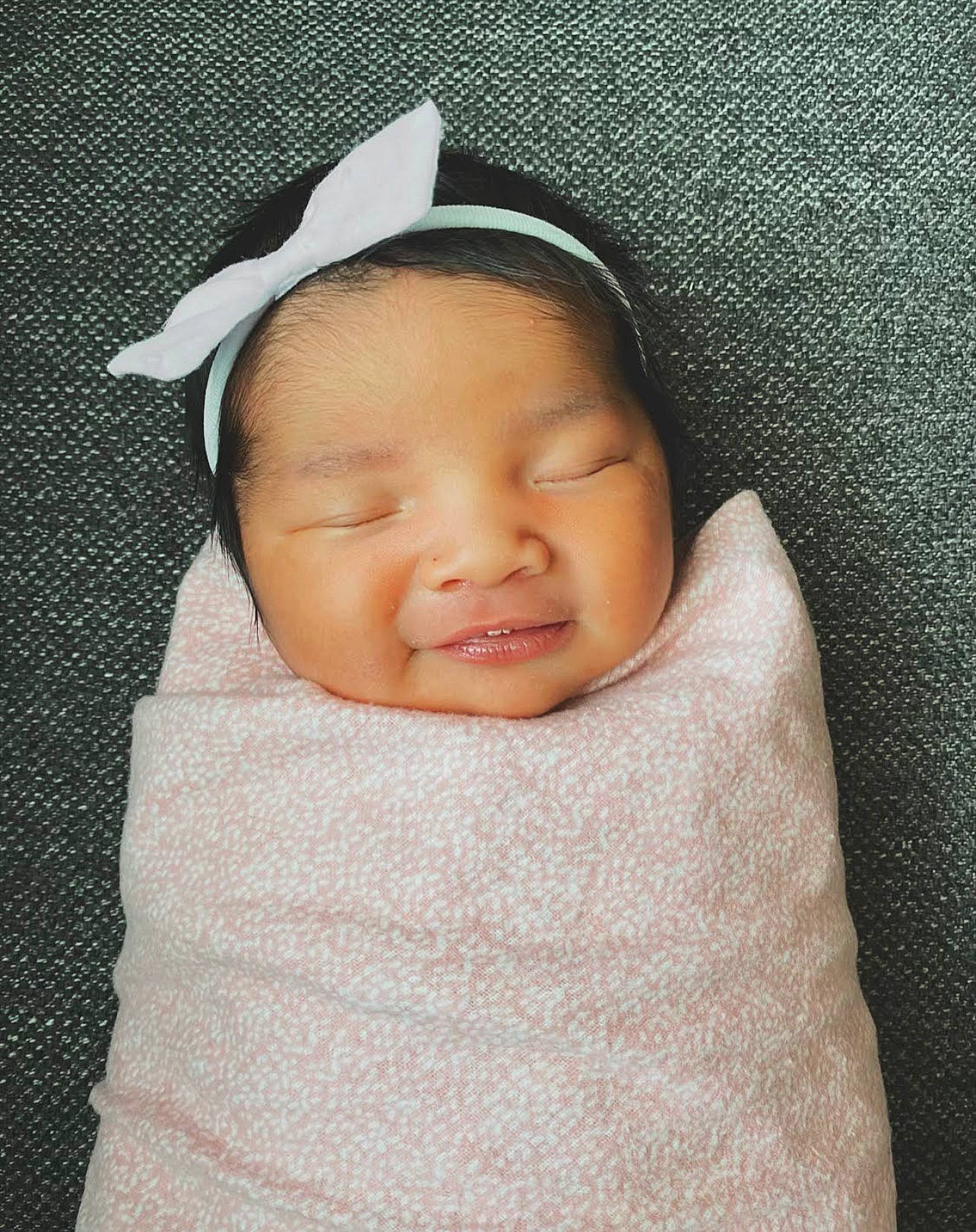 Ava joined the competition — help win amazing prizes! baby, baby_products, baby_sleeping, baby_toddler_clothing, bonnet, cheek, child, comfort, eye, face, fashion_accessory, happy, linens, lip, person, portrait_photography, sleeve, smile, textile, thumb