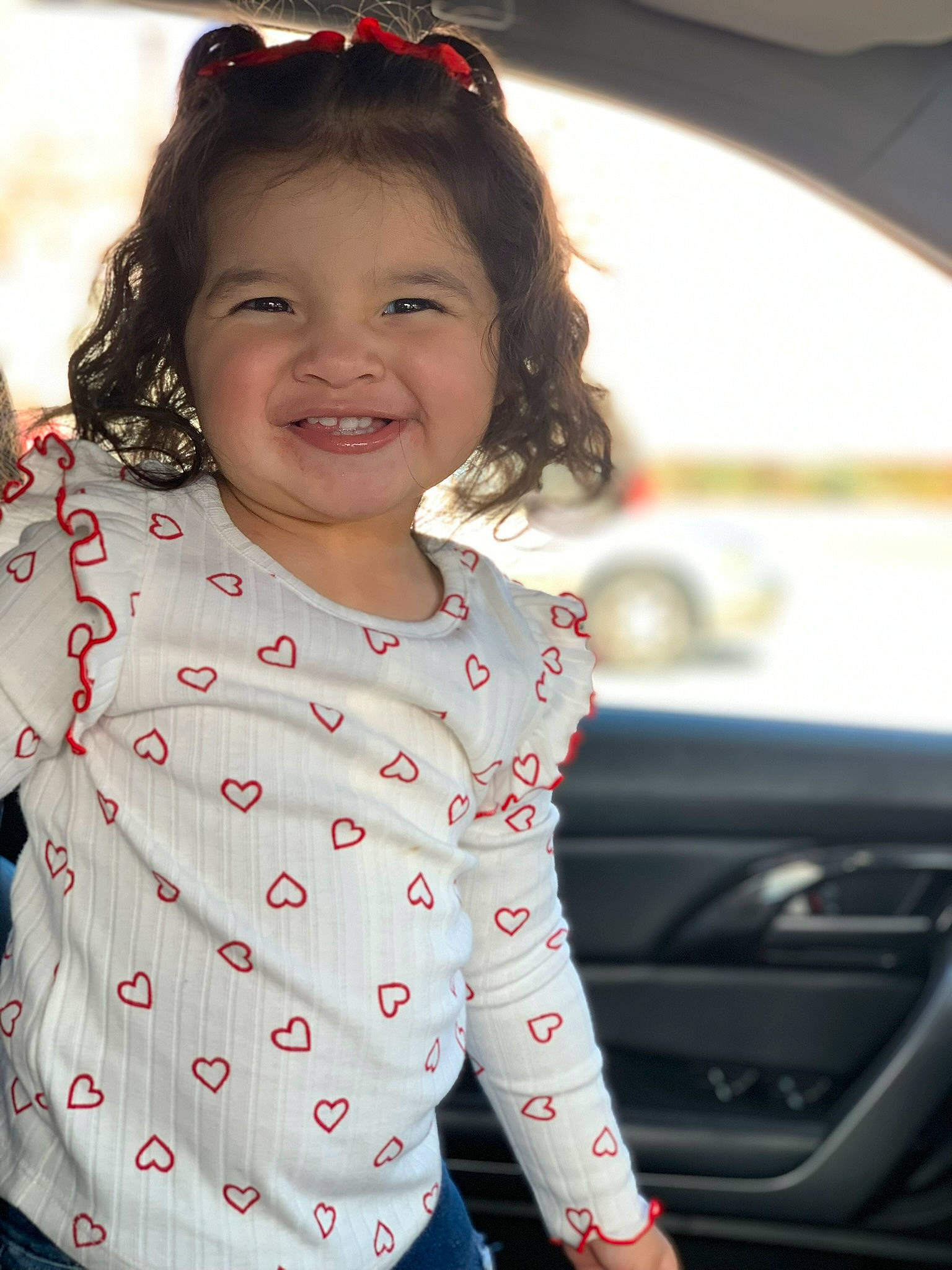 Ava joined the competition — help win amazing prizes! automotive_exterior, automotive_lighting, baby_toddler_clothing, child, face, family_car, fun, gesture, hair, happy, joy, lip, motor_vehicle, pattern, person, skin, sleeve, smile, t_shirt, toddler