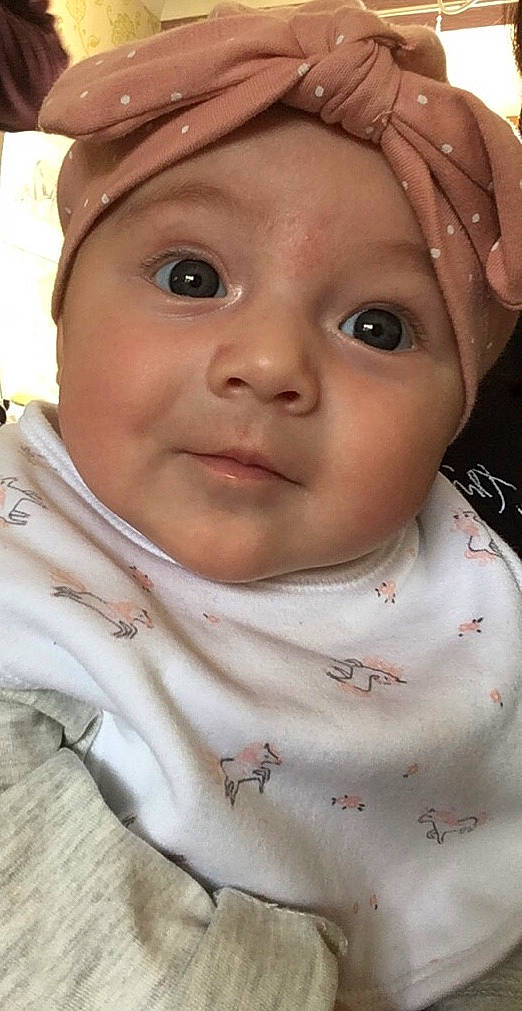 Isobel is registered to the contest to win money with this photo: baby, cheek, child, chin, eye, eyebrow, face, forehead, head, headwear, iris, lip, mouth, neck, nose, person, skin, smile, toddler