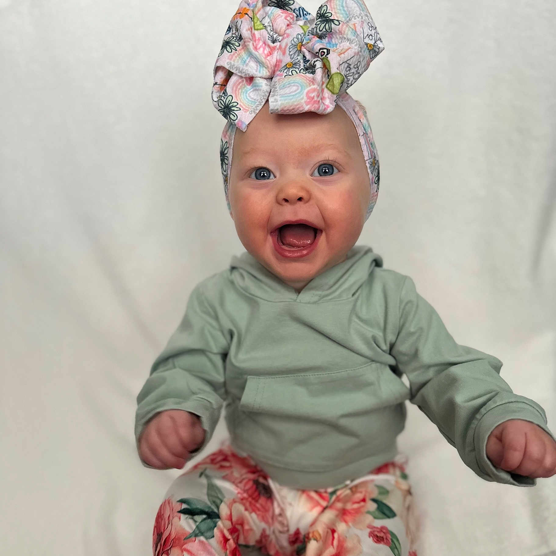 Shiloh is registered to the contest to win money with this photo: baby, babylaughing, bodypart, bonnet, clothing, dress, face, finger, hand, happy, hat, head, newborn, pants, person, photography, portrait, sitting, smile, tape