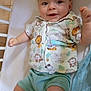 baby, child, crib, mattress, shirt, shorts, smiling, happy, infant, cute, playful, clothing, animal_print, furniture, indoors, person, skin, foot, hand, face