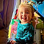baby, babylaughing, bodypart, clothing, coat, dress, face, finger, hand, happy, head, laughing, mouth, person, photography, portrait, smile, teeth, transportation, vehicle