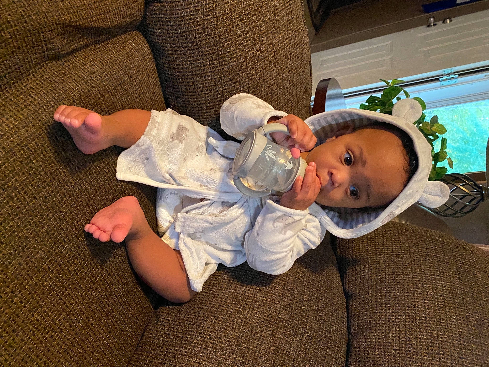 Atlan joined the competition — help win amazing prizes! baby, baby_toddler_clothing, barefoot, cheek, child, comfort, couch, flooring, foot, fun, houseplant, human_body, human_leg, knee, lap, person, sitting, sock, toddler, tree