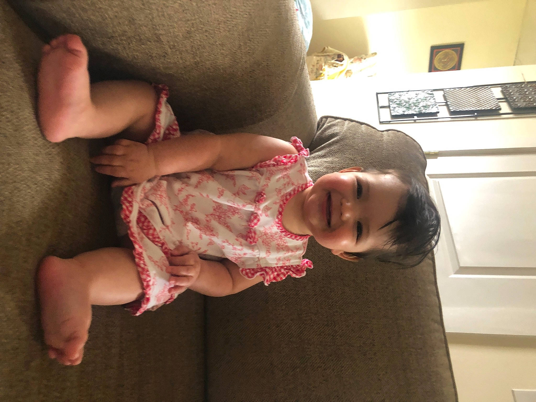 Lucia joined the competition — help win amazing prizes! baby, baby_toddler_clothing, comfort, dress, finger, floor, flooring, gesture, hand, happy, joint, joy, leg, mouth, muscle, person, picture_frame, shoulder, skin, sleeve