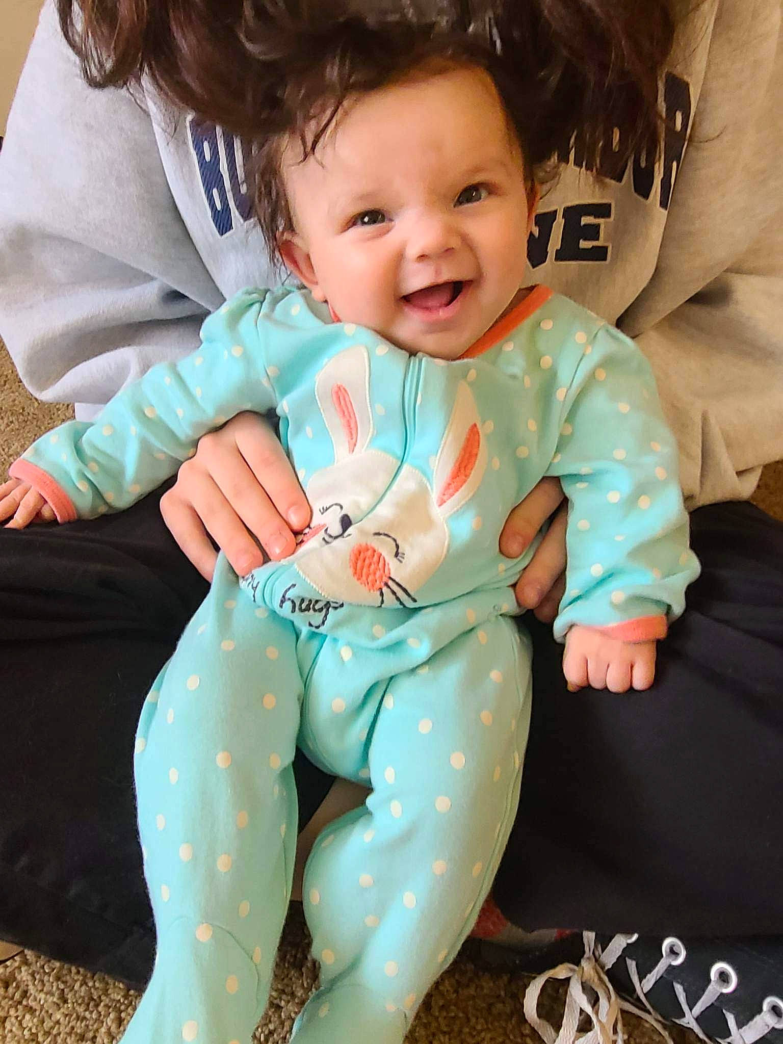 Malaya joined the competition — help win amazing prizes! baby, baby_toddler_clothing, child, comfort, cool, eye, facial_expression, finger, gesture, happy, head, human, joy, lap, leg, person, skin, sleeve, smile, t_shirt