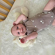 Arthur is registered to the contest to win money with this photo: baby, blanket, blue_eyes, child, comfort, cozy, crib, cute, fluffy, indoors, infant, laying_down, newborn, onesie, plush_toy, portrait, sleeping_area, smile, soft, wooden_crib